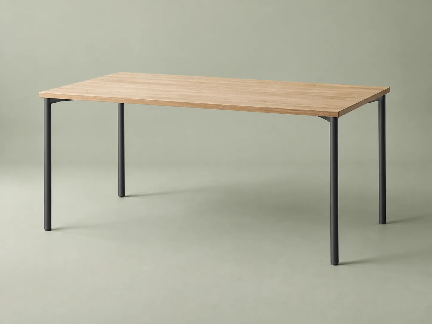An oak studio desk with graphite legs